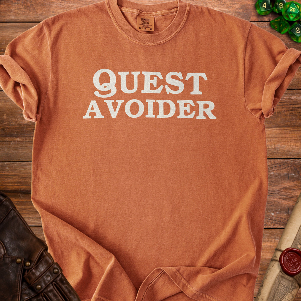 Orange Comfort Colors t-shirt with "QUEST AVOIDER" text.