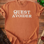 Orange Comfort Colors t-shirt with "QUEST AVOIDER" text.