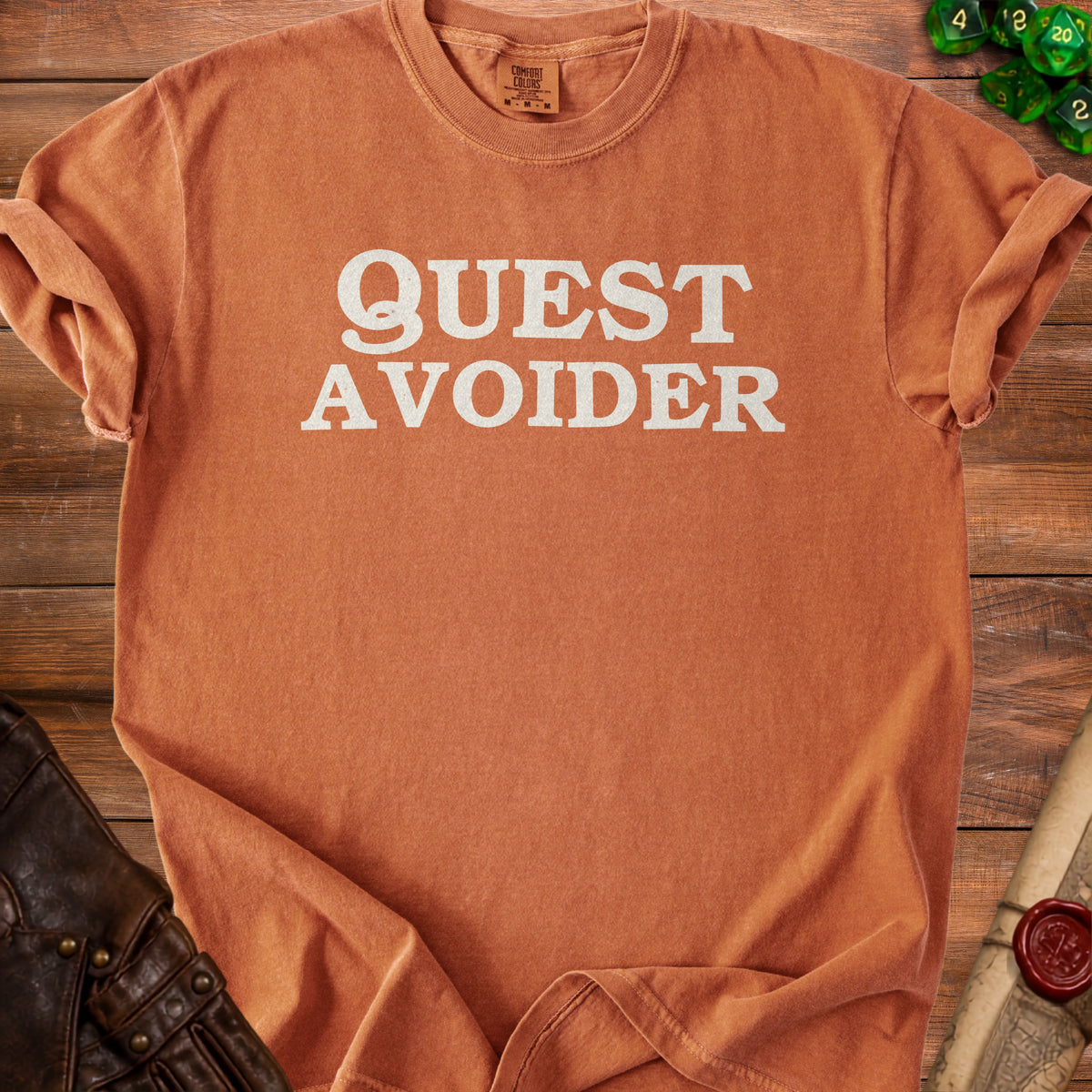 Orange Comfort Colors t-shirt with "QUEST AVOIDER" text.