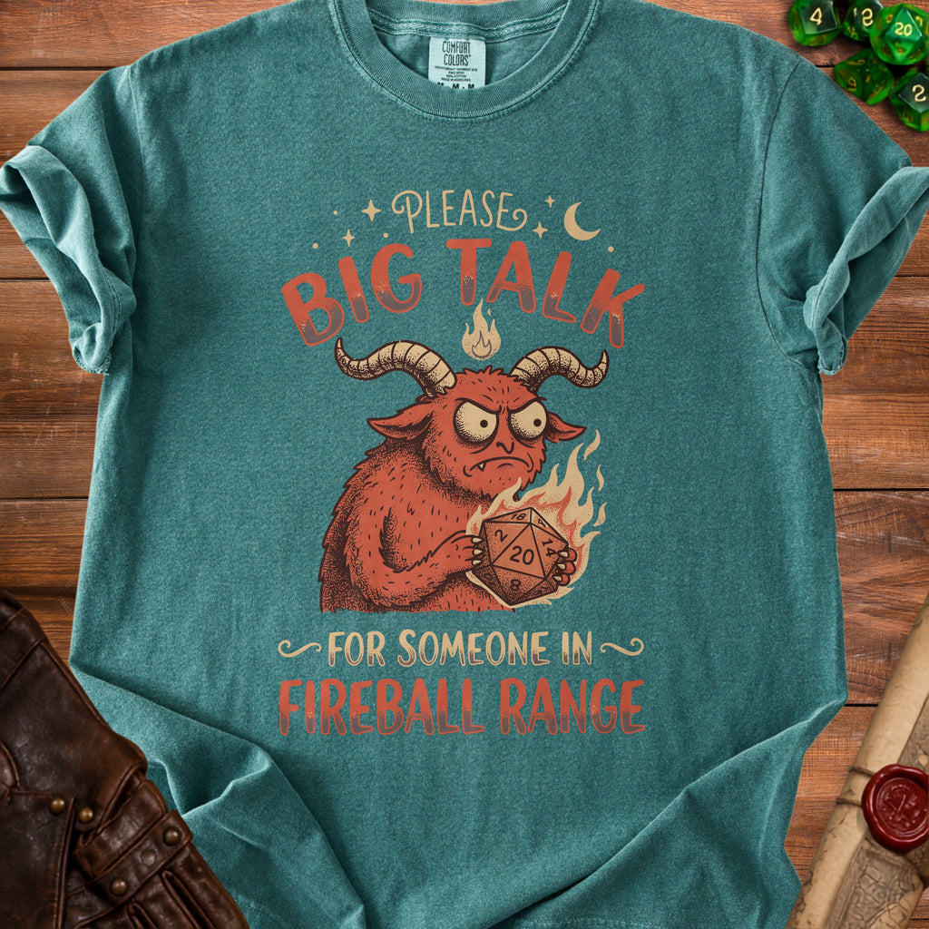 T-shirt with illustration of a demon holding a D20 dice, "Please Big Talk For Someone In Fireball Range."