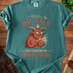 T-shirt with illustration of a demon holding a D20 dice, "Please Big Talk For Someone In Fireball Range."