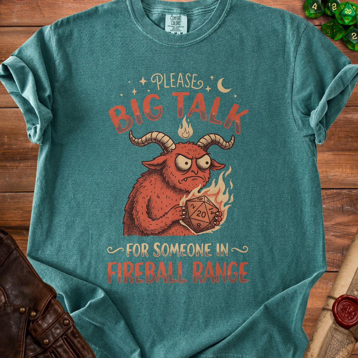 T-shirt with illustration of a demon holding a D20 dice, "Please Big Talk For Someone In Fireball Range."
