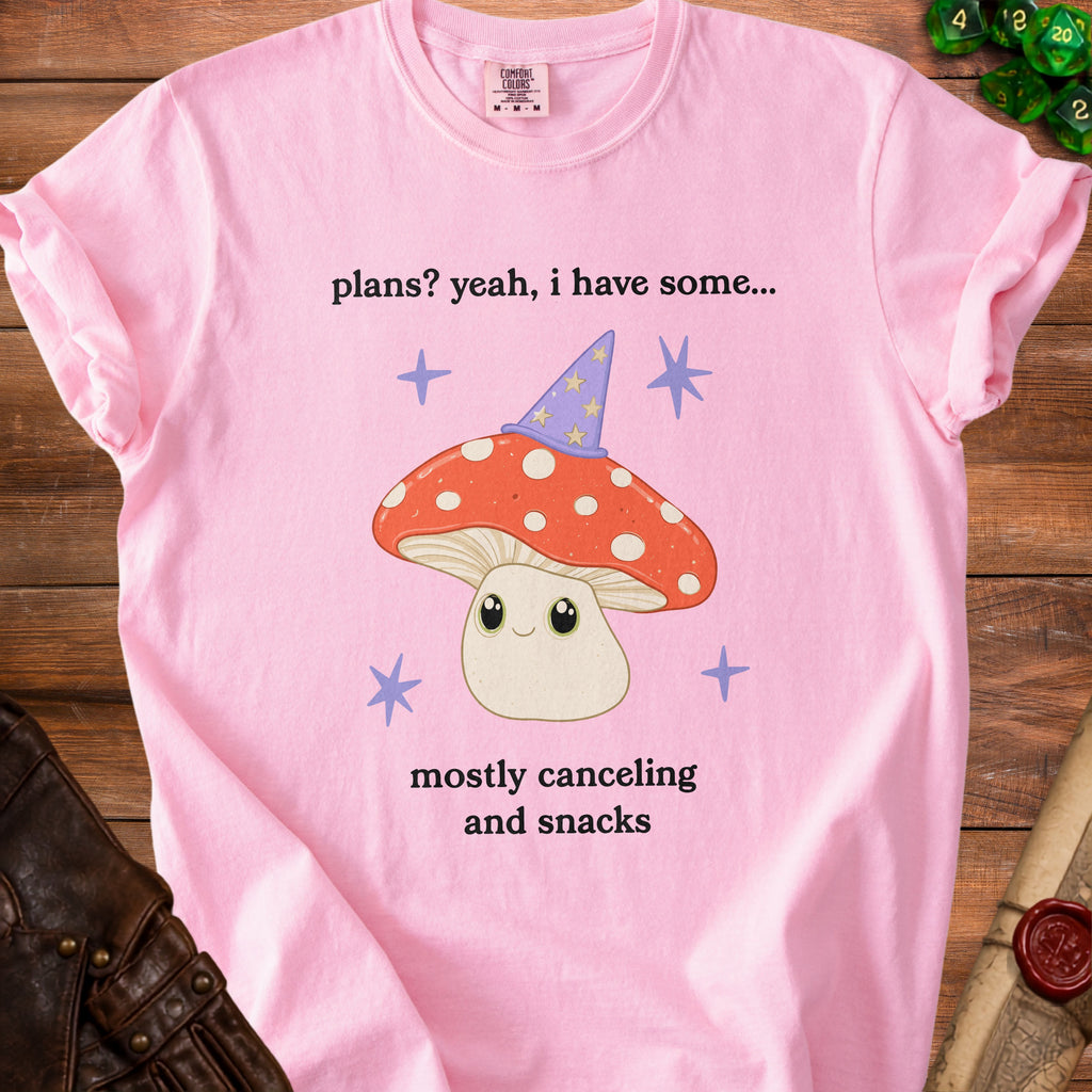 Pink t-shirt with "plans? yeah, i have some... mostly canceling and snacks" and a mushroom graphic.