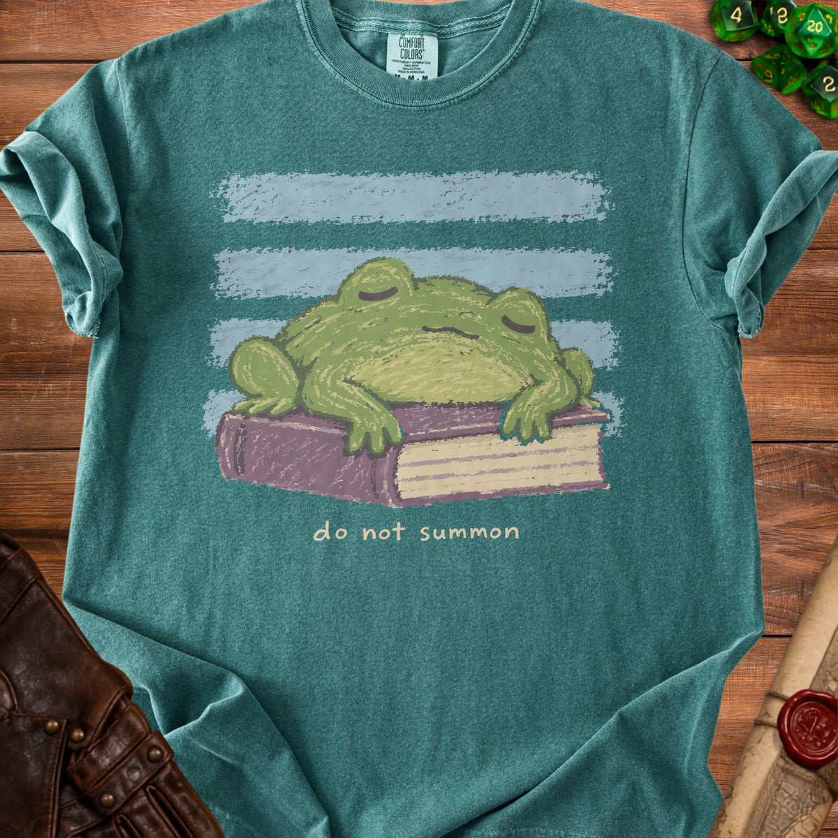 Teal t-shirt with a sleeping frog on a book and "do not summon" text.