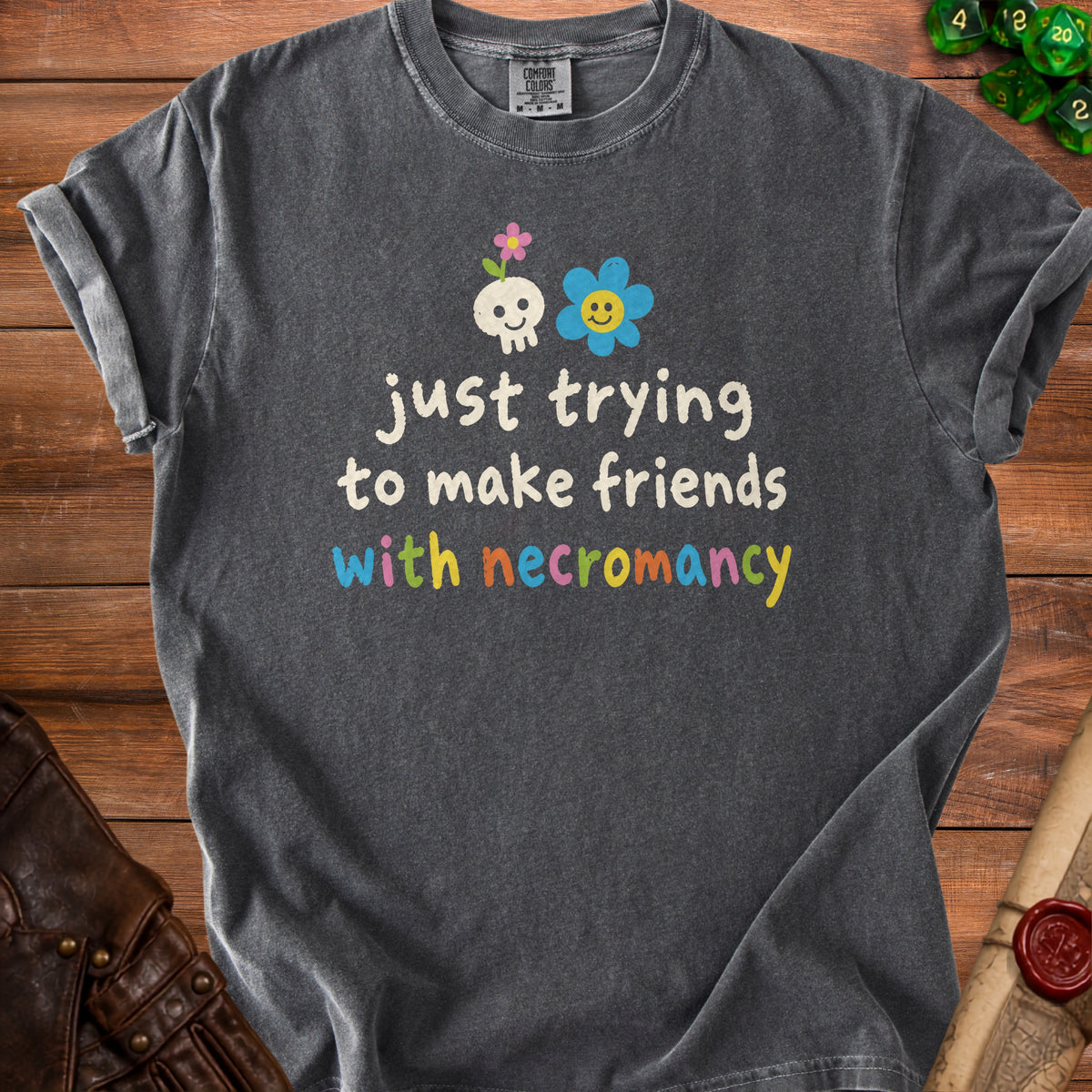 Dark grey t-shirt with "just trying to make friends with necromancy" text.