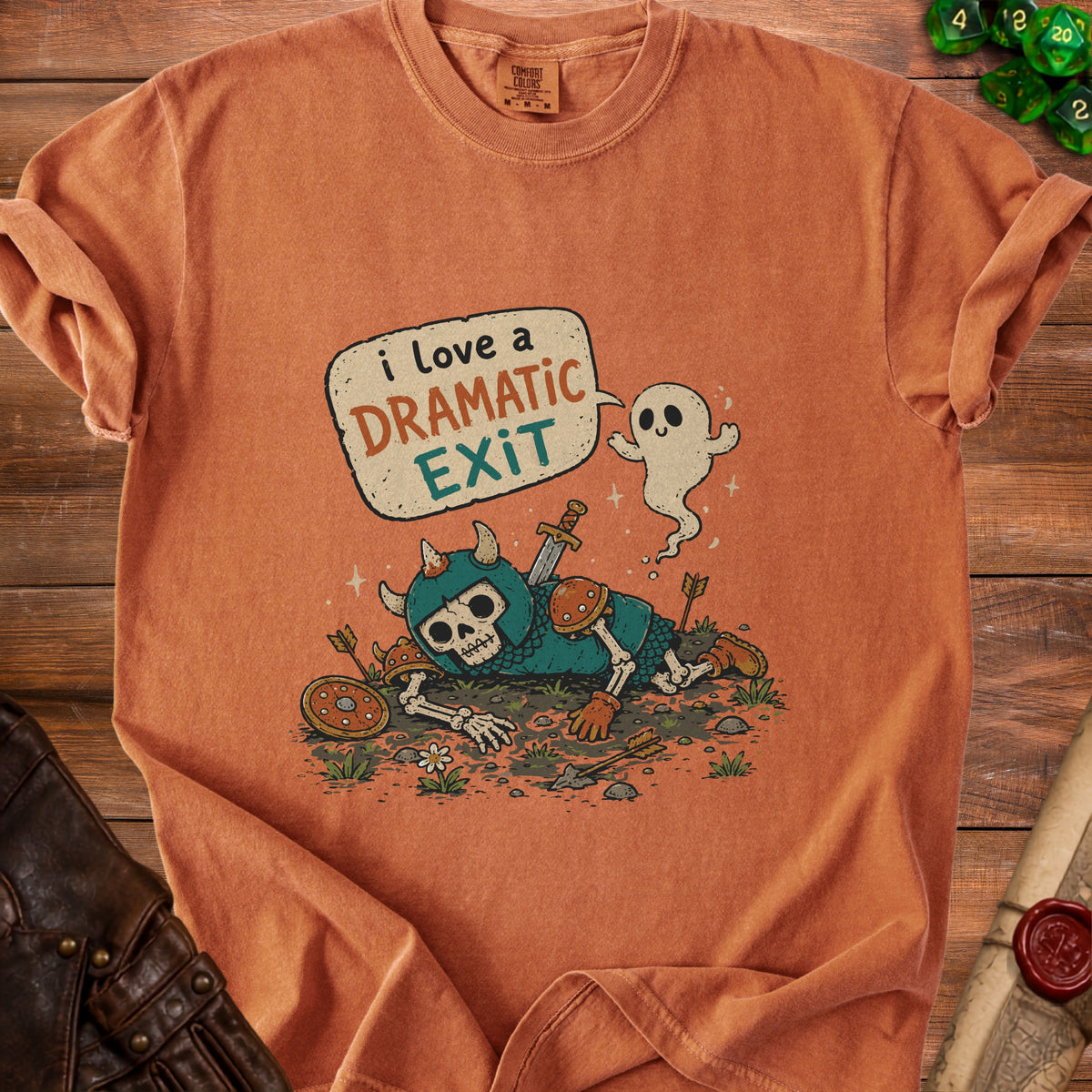 Orange t-shirt with a skeleton warrior, ghost, and speech bubble saying "i love a DRAMATIC EXIT".