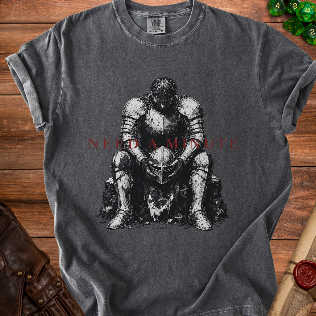 Dark grey t-shirt with distressed knight illustration and red text "NEED A MINUTE".