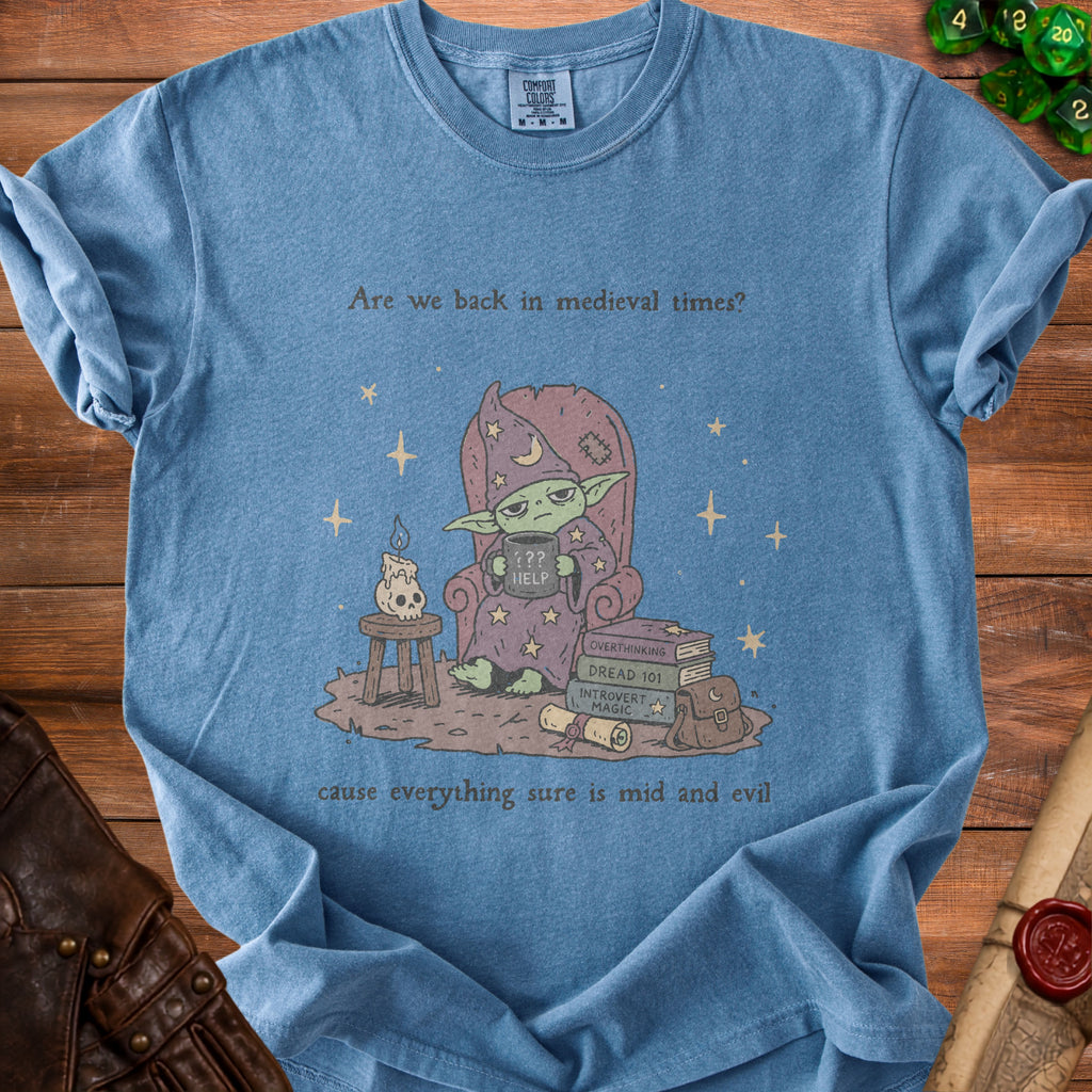 Blue t-shirt with cartoon wizard holding a "HELP" mug and books titled "Overthinking" and "Introvert Magic."