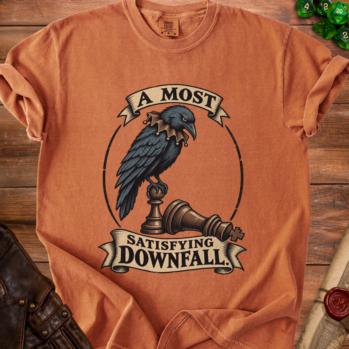 Terracotta t-shirt featuring a crow in a jester collar perched on a chess piece with text.