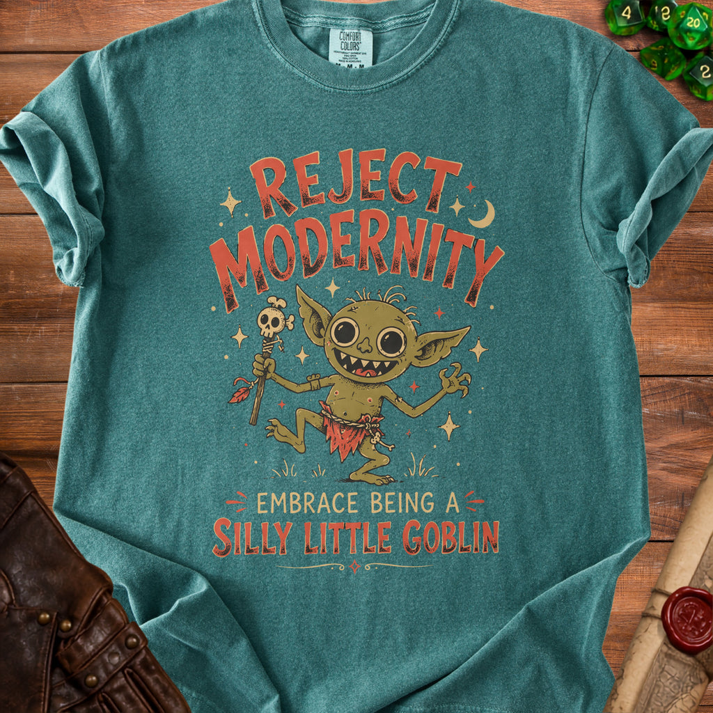 Green t-shirt with a goblin graphic and text "REJECT MODERNITY EMBRACE BEING A SILLY LITTLE GOBLIN".