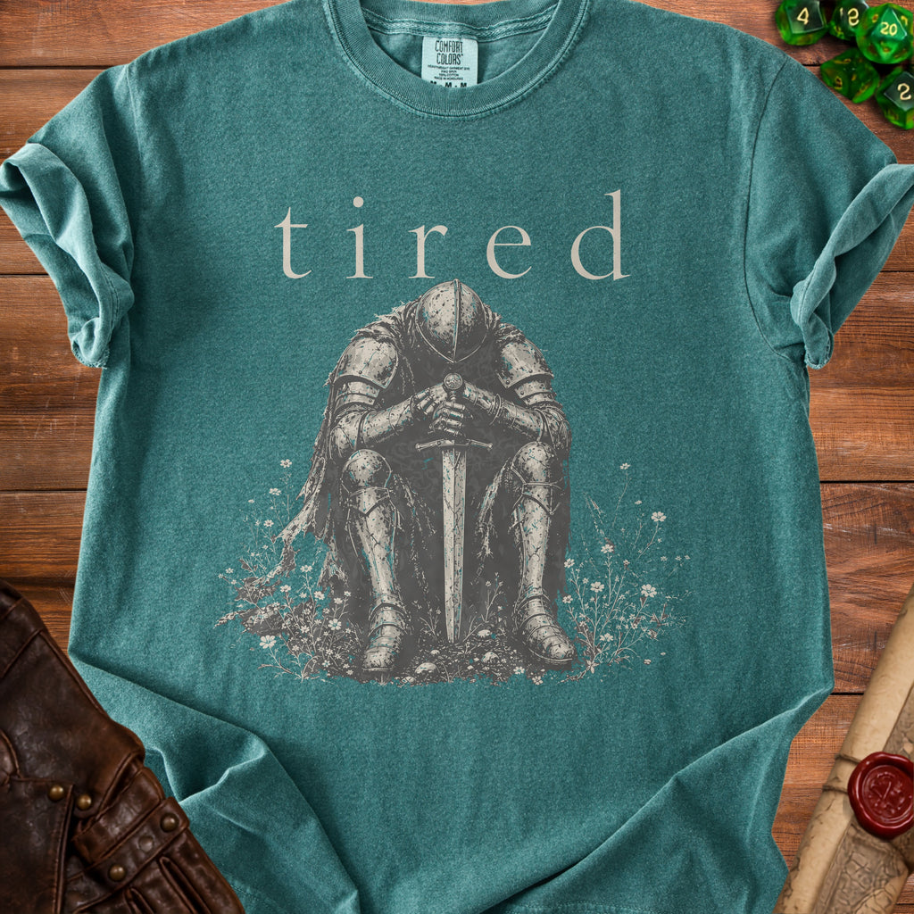 T-shirt with knight and sword graphic, text reads "tired".