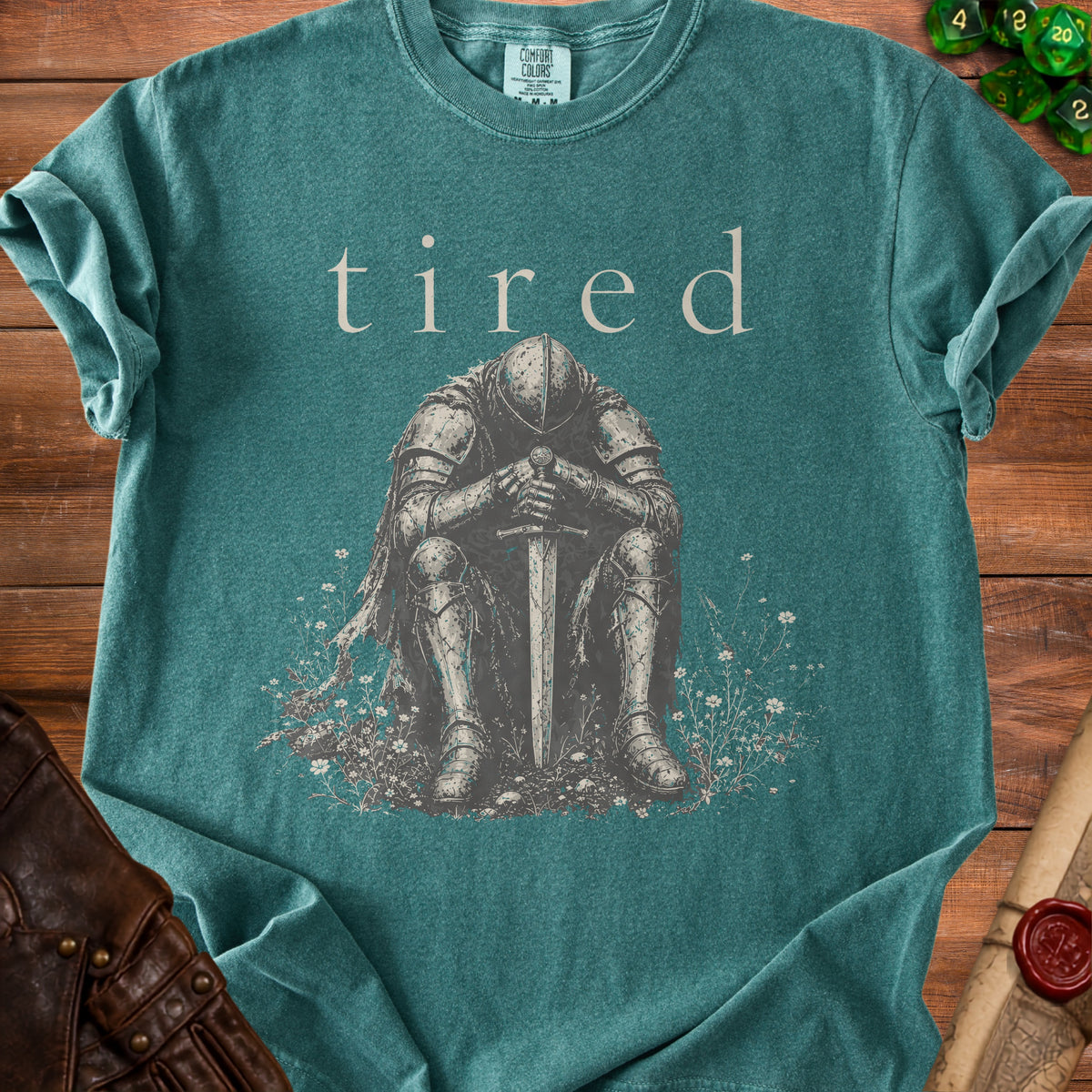 T-shirt with knight and sword graphic, text reads "tired".