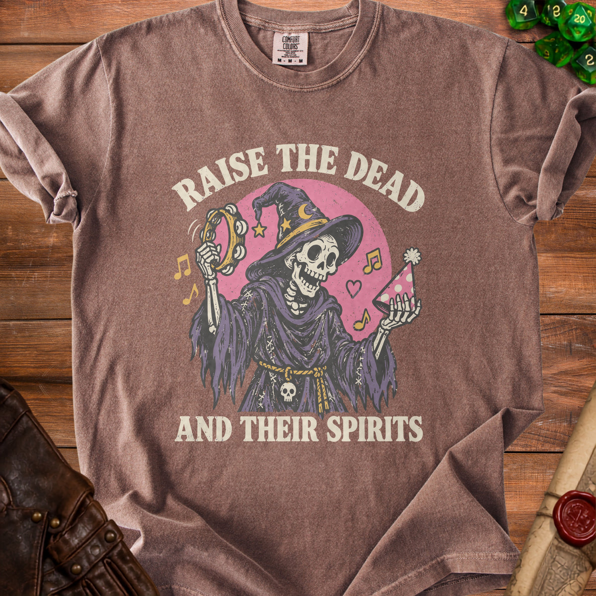 Skeleton in witch hat holding tambourine with text "Raise the Dead and their spirits".
