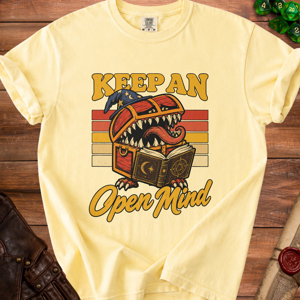 Yellow t-shirt with "Keep an Open Mind" text and a monster treasure chest graphic.