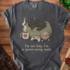 Dark gray t-shirt with a sleeping cat, controller, popcorn, and text.