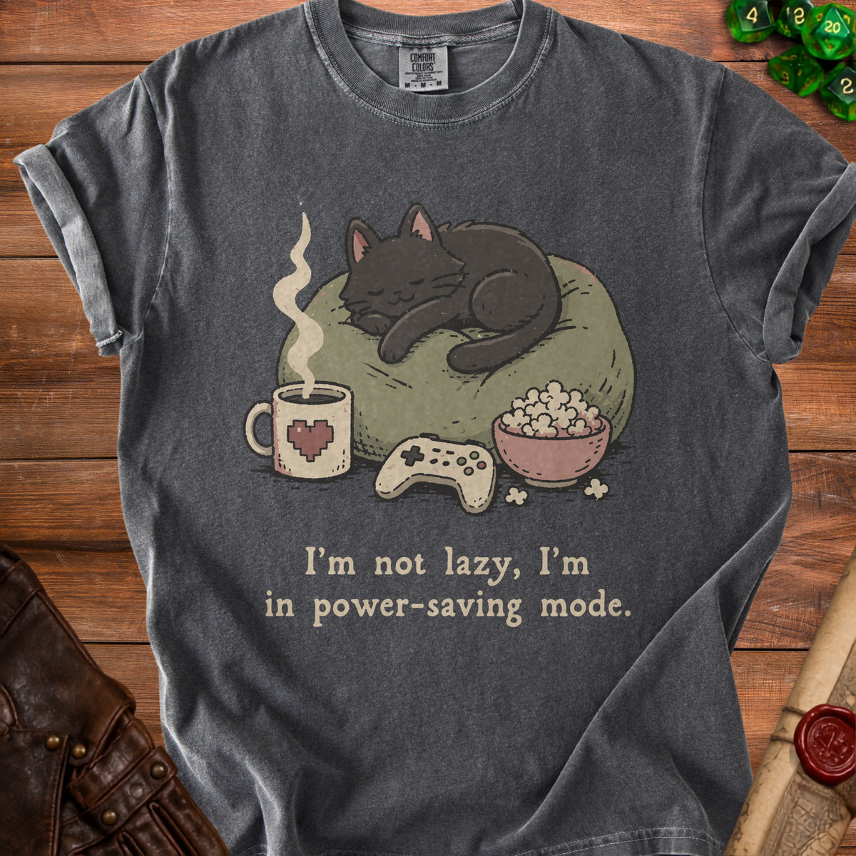 Dark gray t-shirt with a sleeping cat, controller, popcorn, and text.