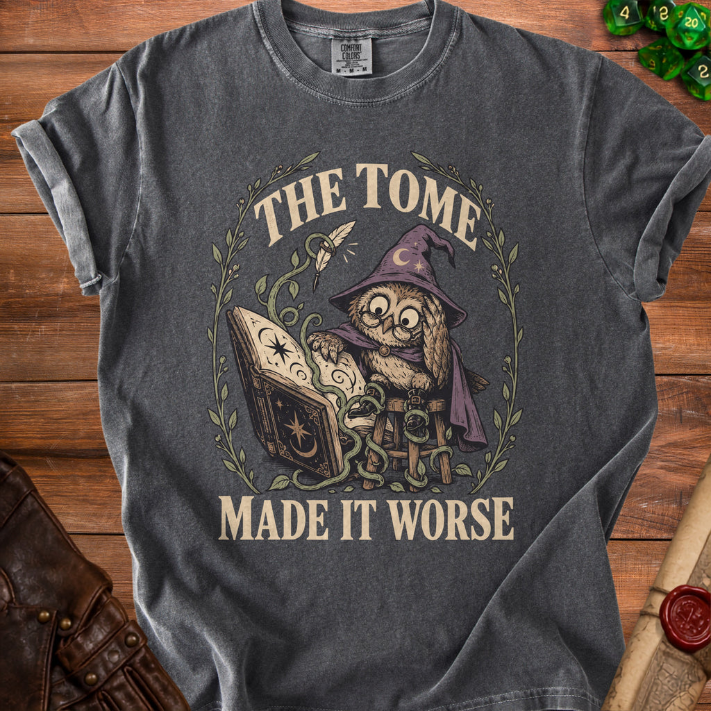 Dark grey t-shirt with a graphic of an owl in a witch hat reading a book, text says "The Tome Made It Worse".