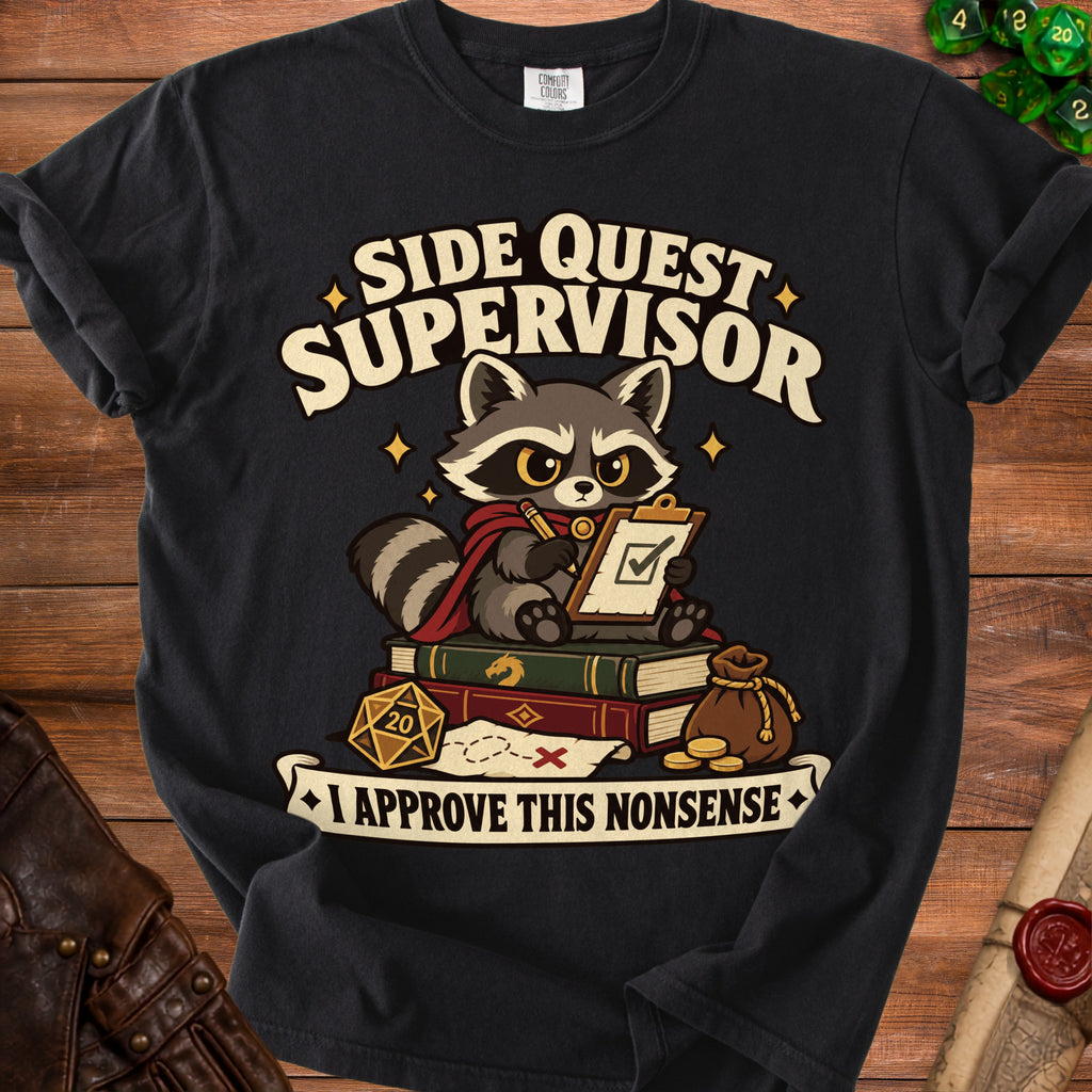 A black t-shirt featuring a cartoon raccoon sitting on books with a clipboard, twenty-sided die, and text reading Side Quest Supervisor.