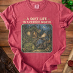 T-shirt with "A Soft Life In A Cursed World" text and wizard reading with dragon.