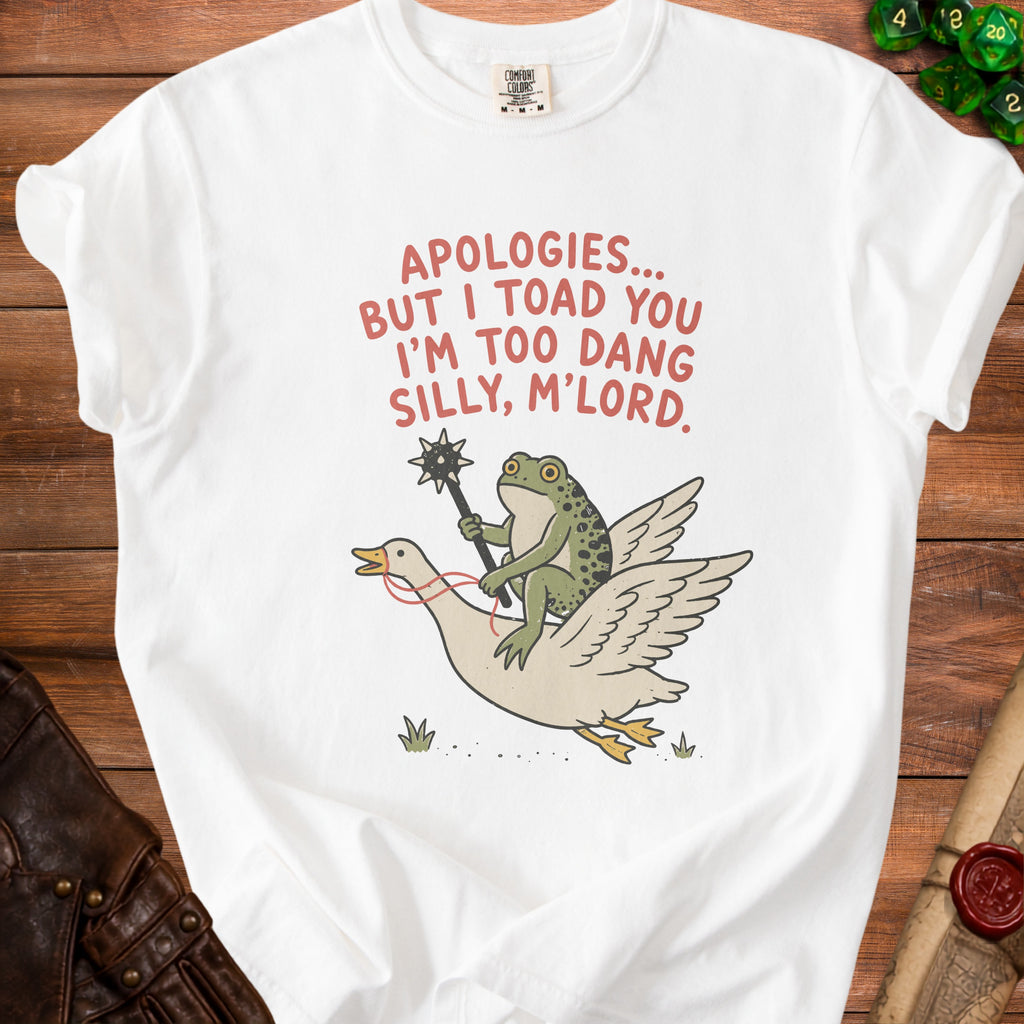 White t-shirt with red text "APOLOGIES... BUT I TOAD YOU I'M TOO DANG SILLY, M'LORD." and cartoon frog riding goose.
