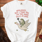 White t-shirt with red text "APOLOGIES... BUT I TOAD YOU I'M TOO DANG SILLY, M'LORD." and cartoon frog riding goose.