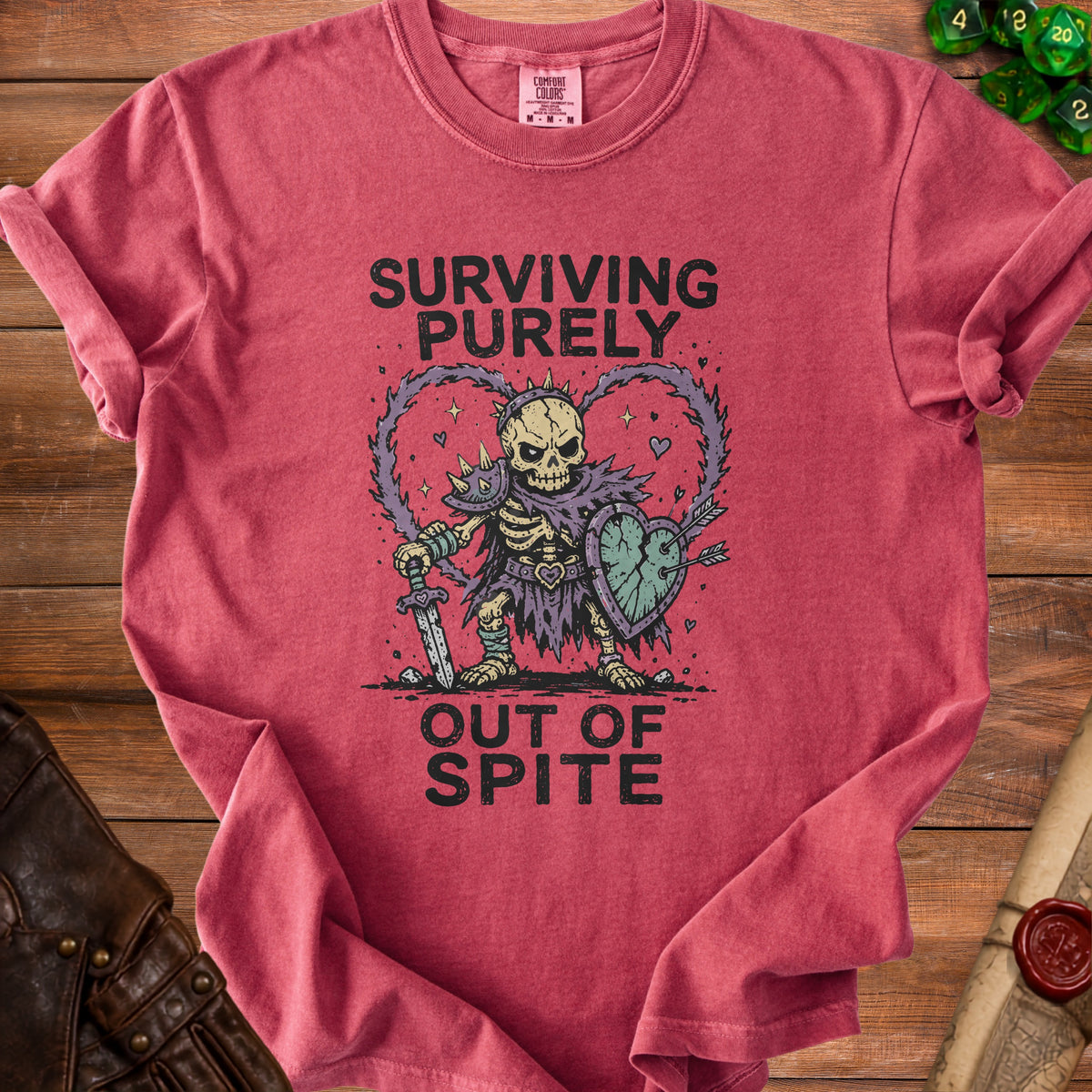 T-shirt with skeleton warrior graphic and text "Surviving Purely Out of Spite."