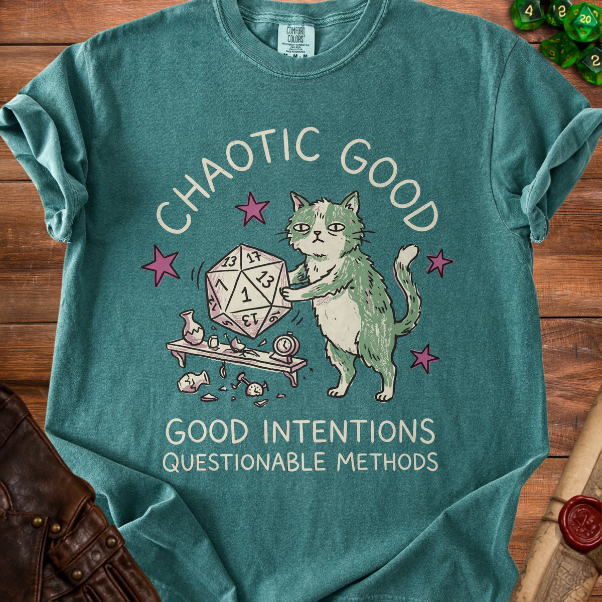 Green t-shirt with cat holding dice and text "CHAOTIC GOOD GOOD INTENTIONS QUESTIONABLE METHODS".