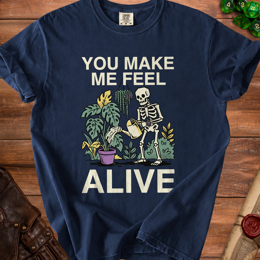 Navy t-shirt with skeleton watering plants and text "YOU MAKE ME FEEL ALIVE".