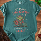Teal t-shirt with goblin, sword, shield, dice, and text "SO MANY SIDE QUESTS SO LITTLE LOOT".
