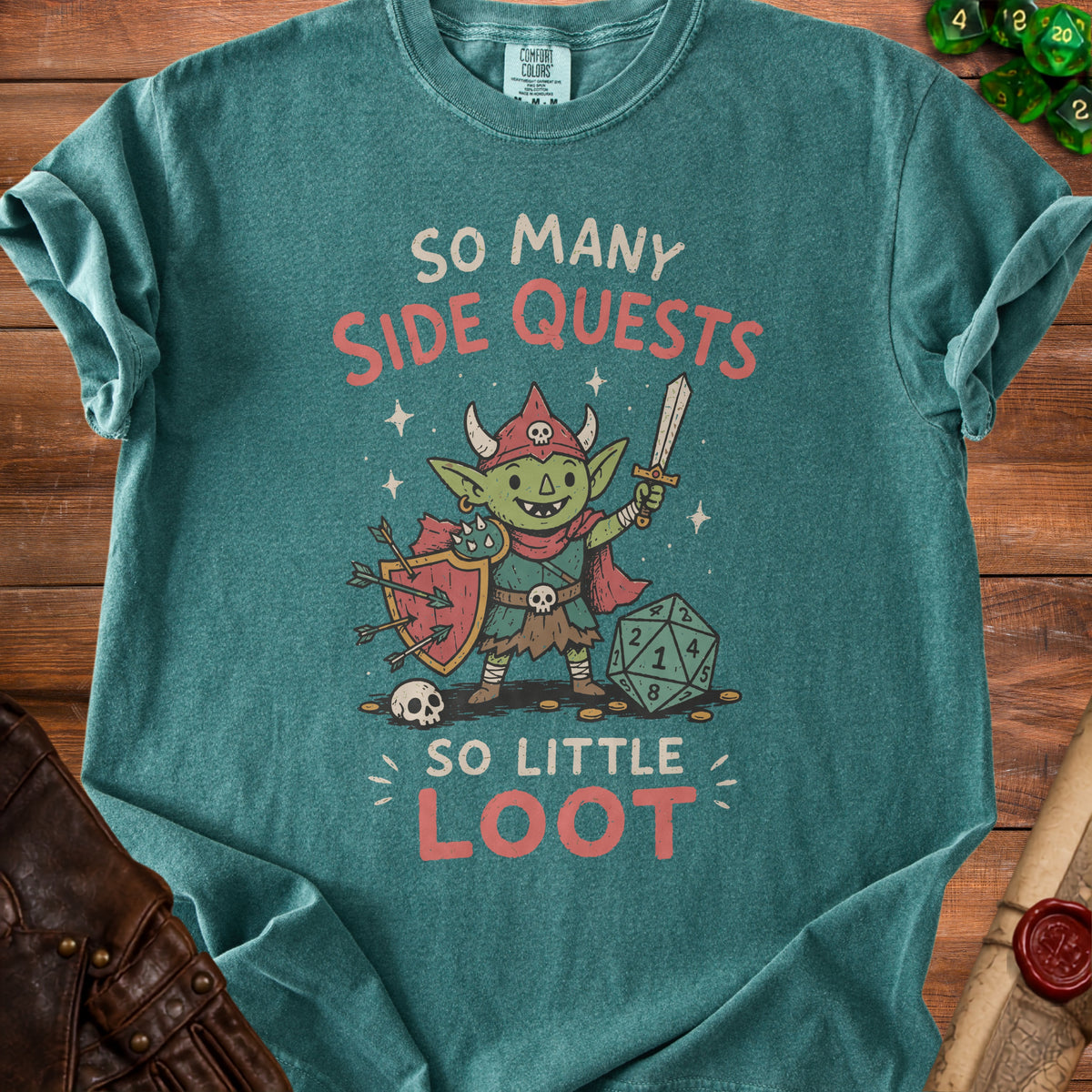 Teal t-shirt with goblin, sword, shield, dice, and text "SO MANY SIDE QUESTS SO LITTLE LOOT".