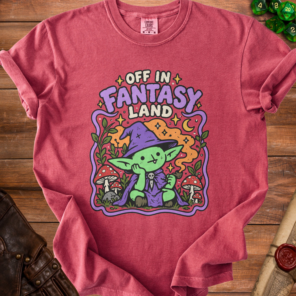 T-shirt with graphic of green creature in wizard hat, text "Off In Fantasy Land".