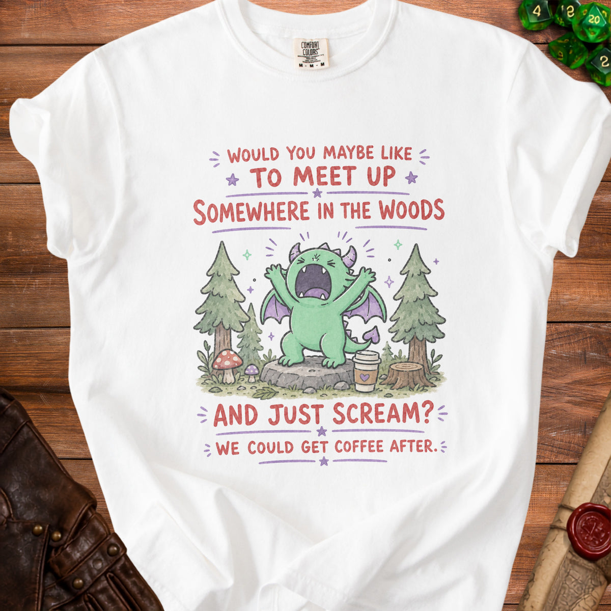 White t-shirt with green dragon screaming in woods, "We could get coffee after" text.