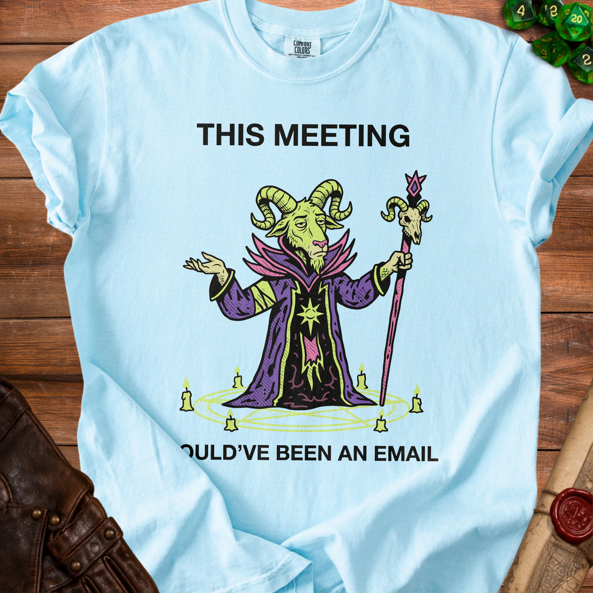Light blue t-shirt with goat wizard graphic and text "THIS MEETING OULD'VE BEEN AN EMAIL".