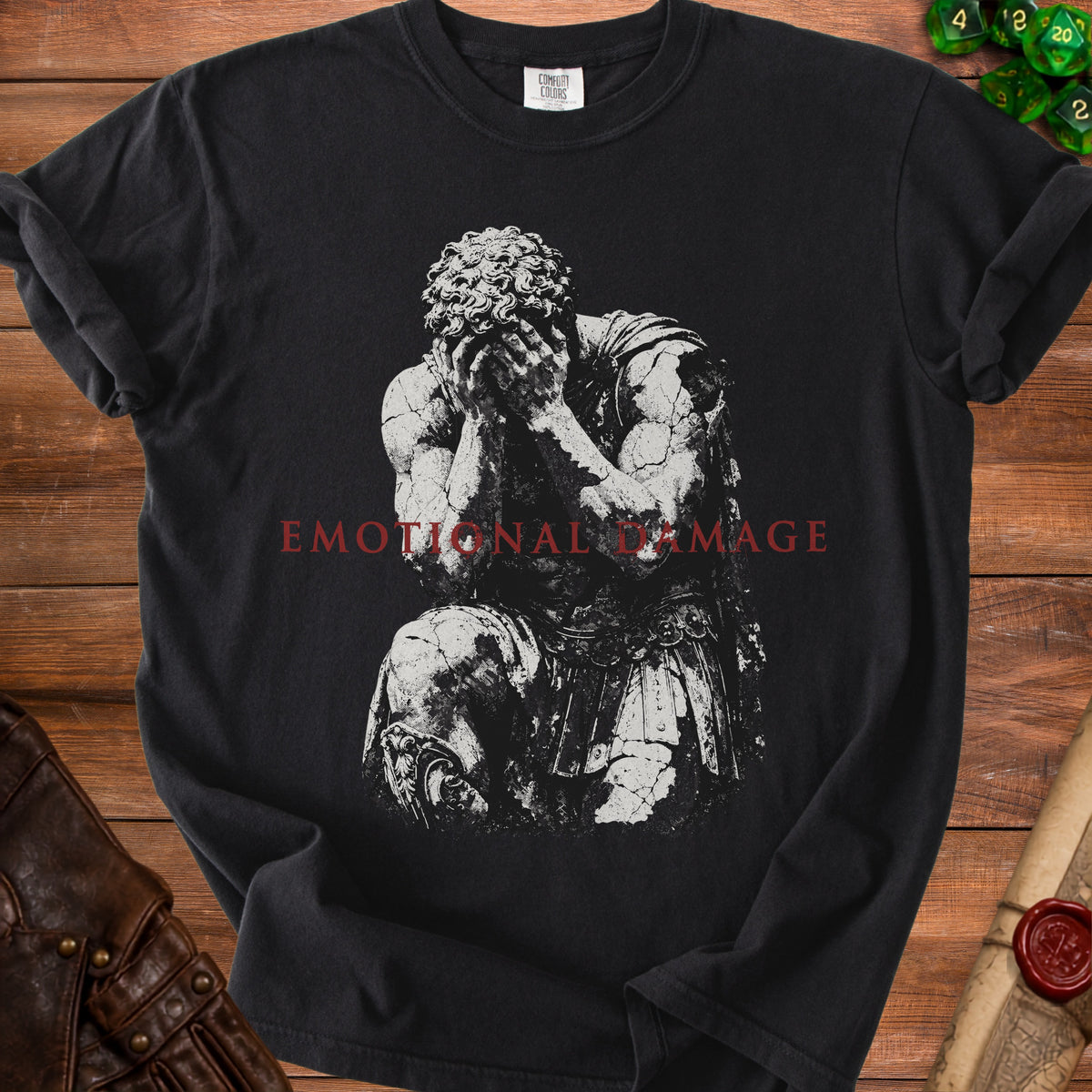 Black t-shirt with cracked statue artwork and red text "EMOTIONAL DAMAGE".