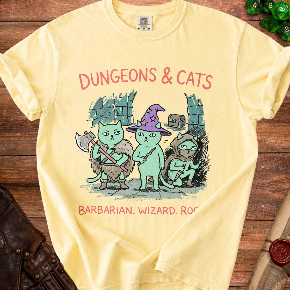 Yellow t-shirt with cartoon cats dressed as barbarian, wizard, and rogue. Dungeons & Cats text.