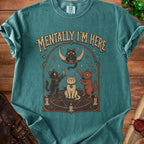 Teal t-shirt with occult cats, moon, candles, and text "MENTALLY I'M HERE".