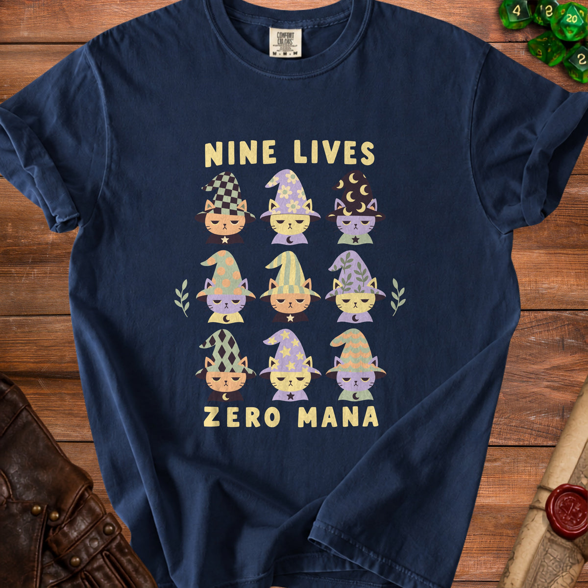 Dark blue t-shirt with "Nine Lives Zero Mana" and nine cats wearing wizard hats.