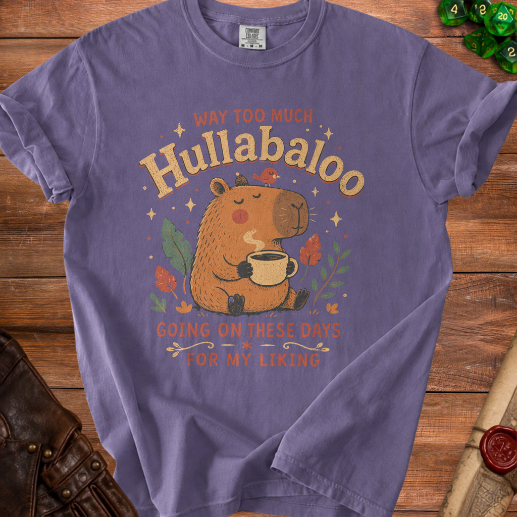 Purple t-shirt with a capybara drinking coffee and text "Hullabaloo Going On These Days For My Liking".