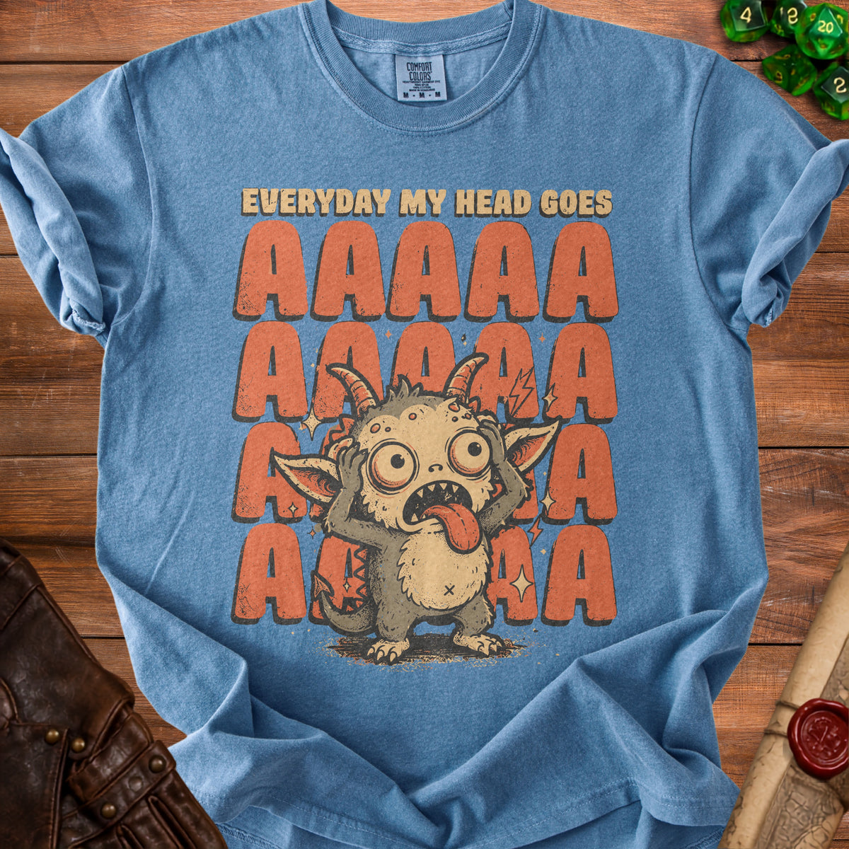 Blue t-shirt with a distressed graphic of a monster and text "Everyday my head goes AAAAA".