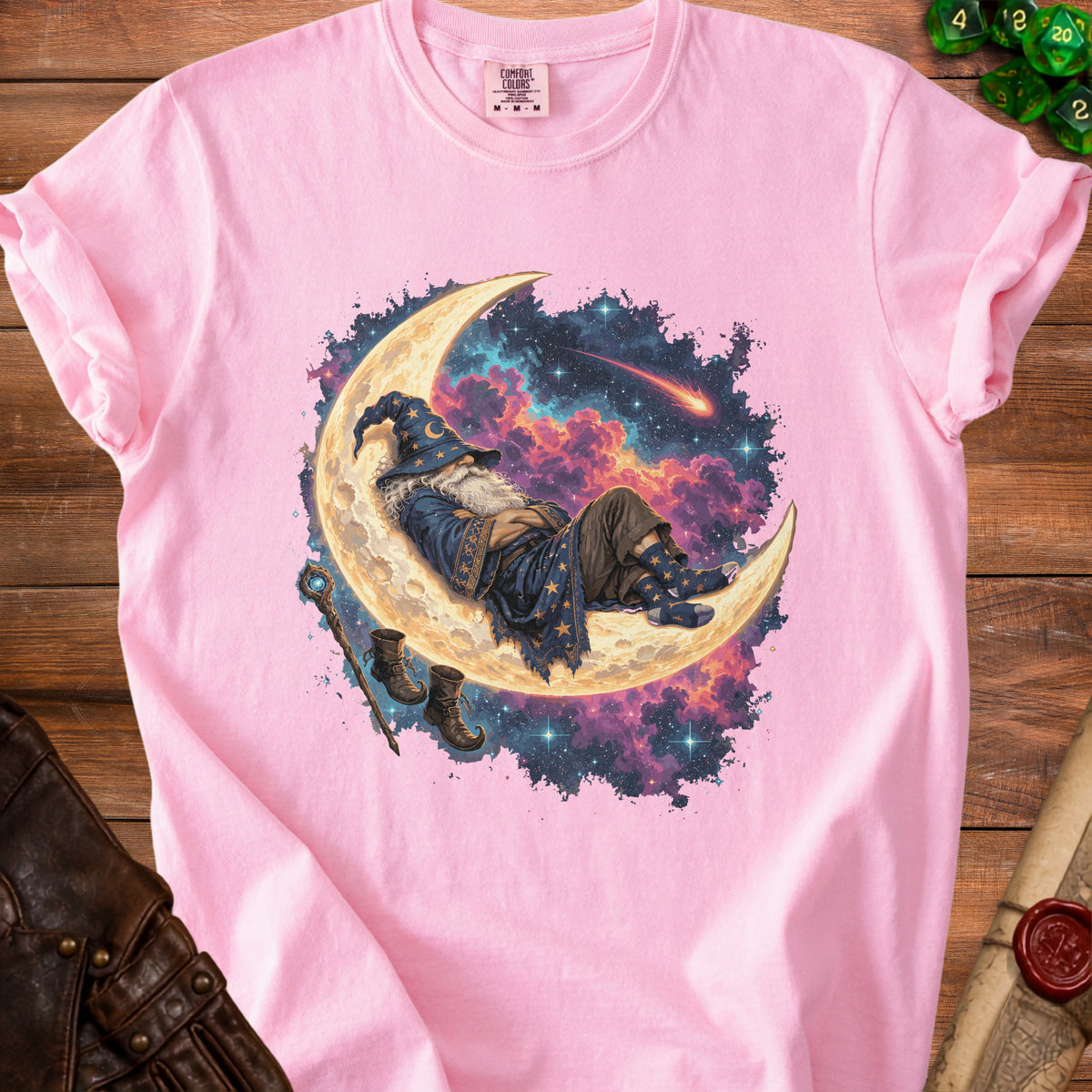 Pink t-shirt with a wizard sleeping on the moon under a starry sky.