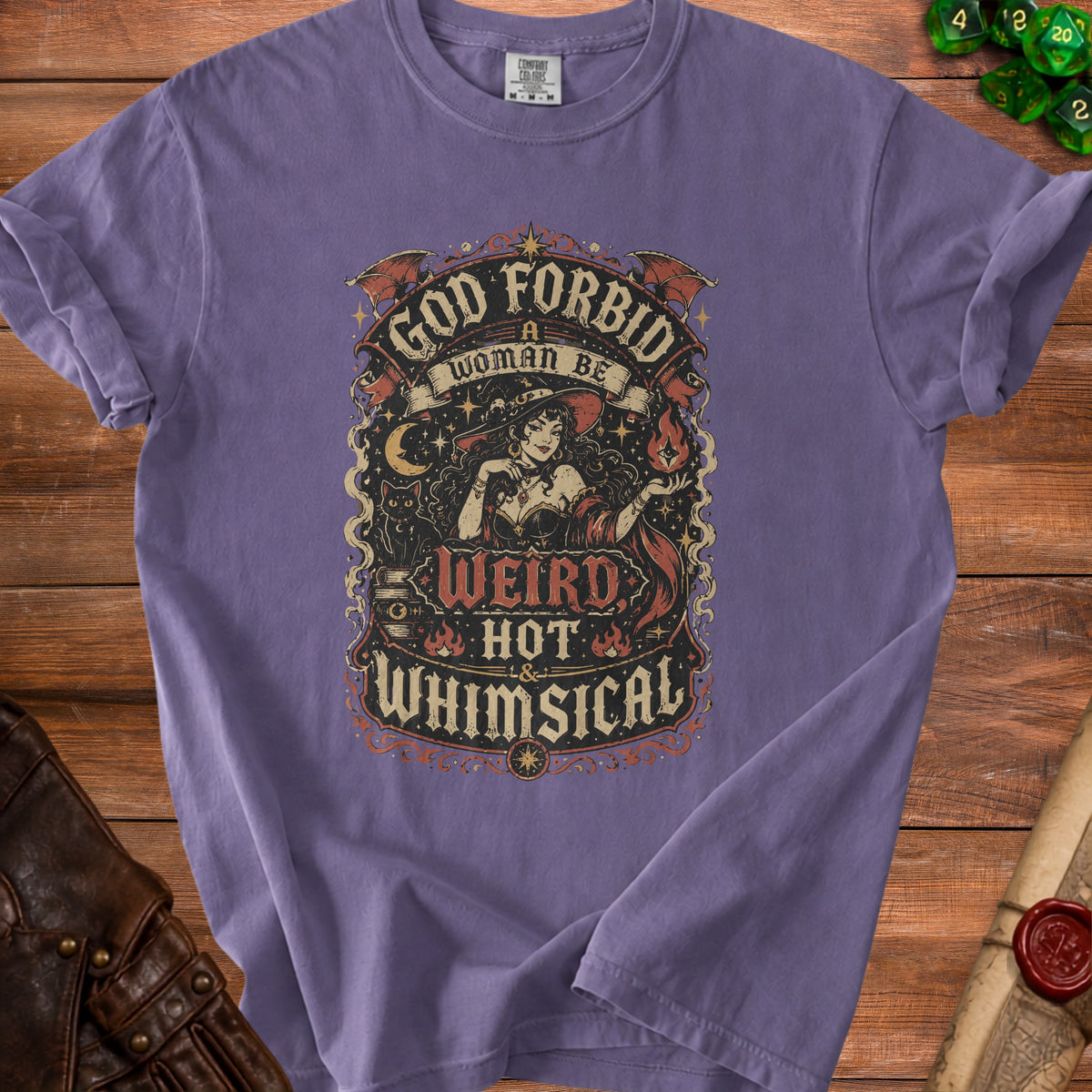 Purple t-shirt with "God forbid a woman be weird, hot & whimsical" text and witch graphic.