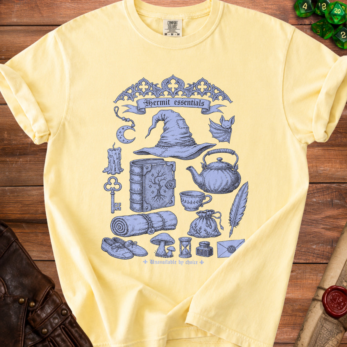 Yellow t-shirt with "Hermit essentials" and whimsical illustrations.