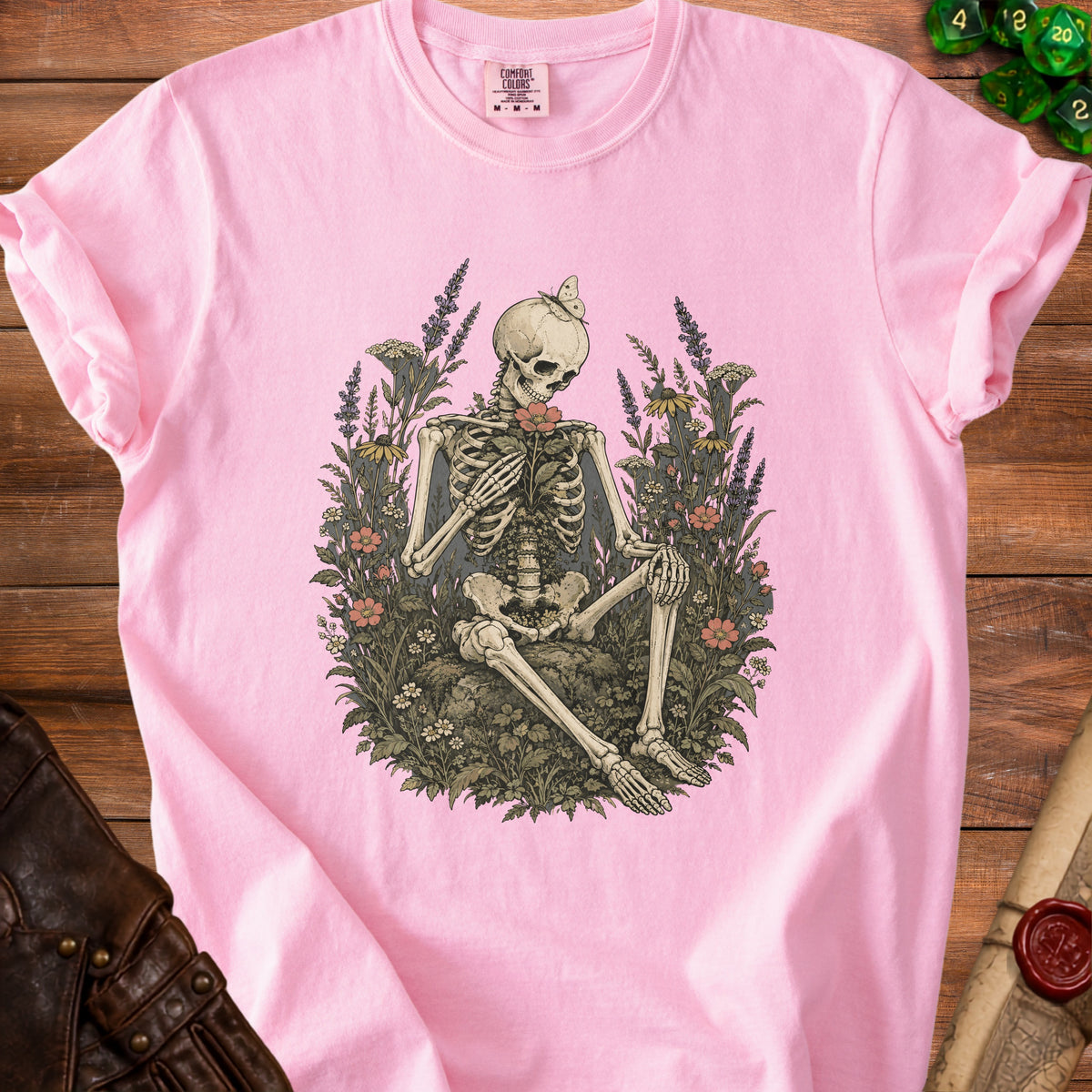 Pink t-shirt with skeleton and flowers graphic, butterfly on skull.
