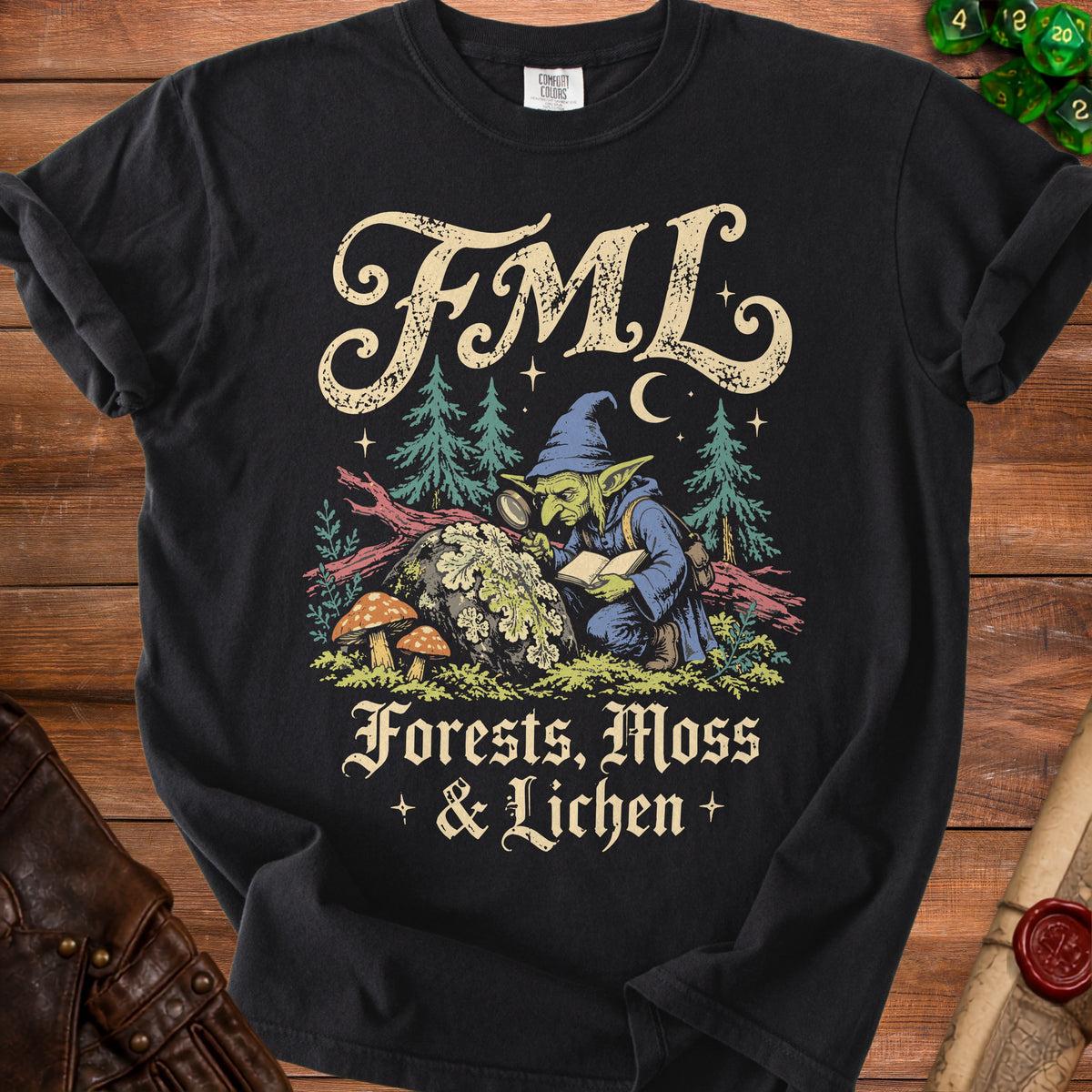 Black t-shirt with a goblin using a magnifying glass, text "FML Forests, Moss & Lichen".
