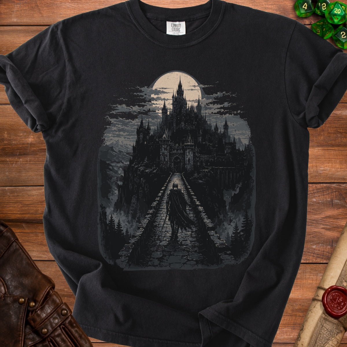Dark t-shirt with a castle and knight graphic under a full moon.