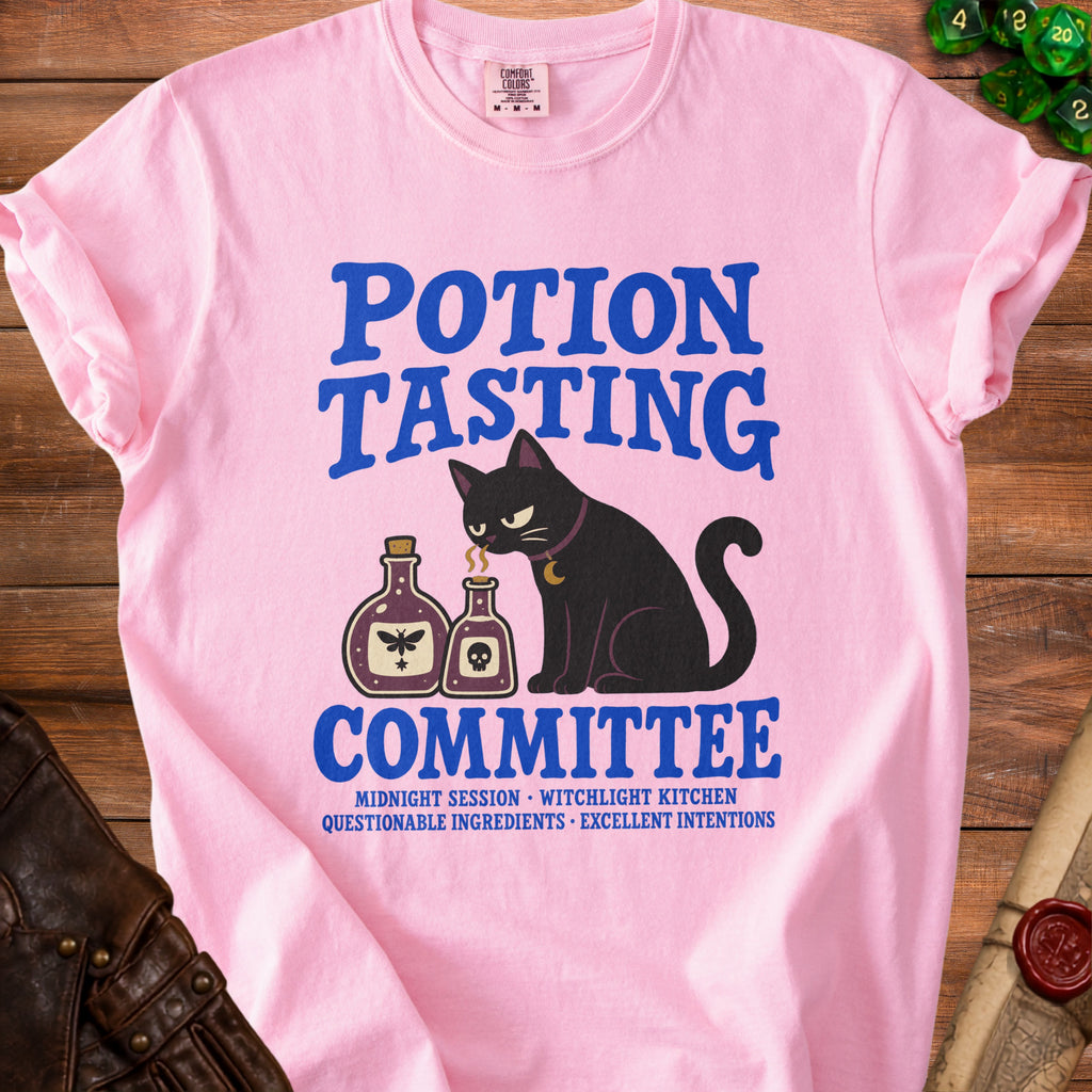 Pink t-shirt with "Potion Tasting Committee" design featuring a black cat and potion bottles.