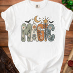 White t-shirt with "MAGIC" in floral, retro lettering, moon, bats, and stars.