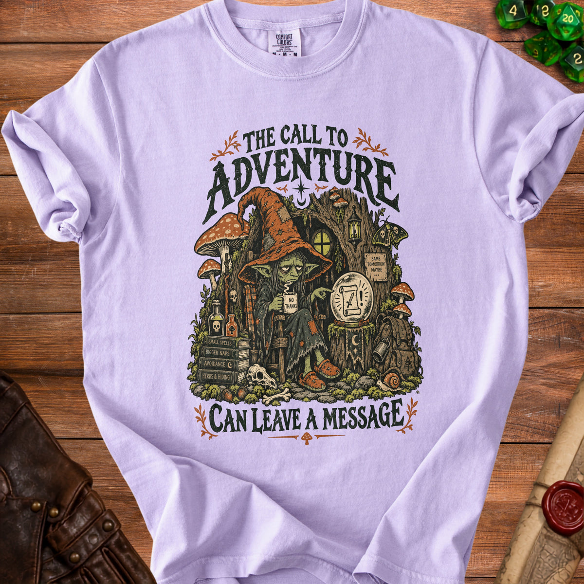 Lilac t-shirt with "The Call to Adventure Can Leave a Message" graphic.