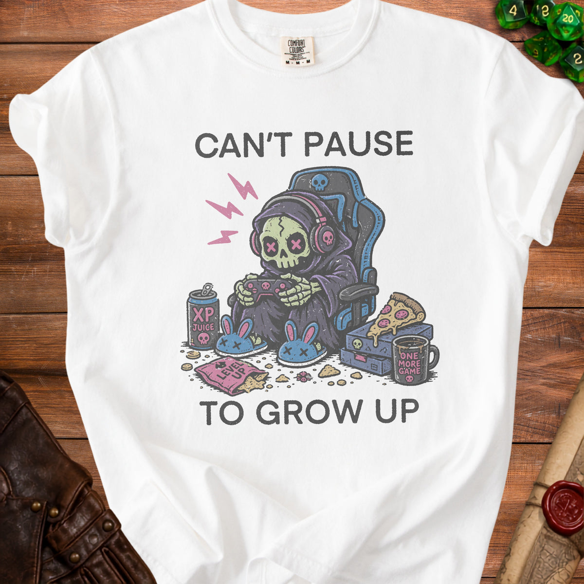 White t-shirt graphic with grim reaper gamer, XP juice, pizza, and "Can't Pause to Grow Up".