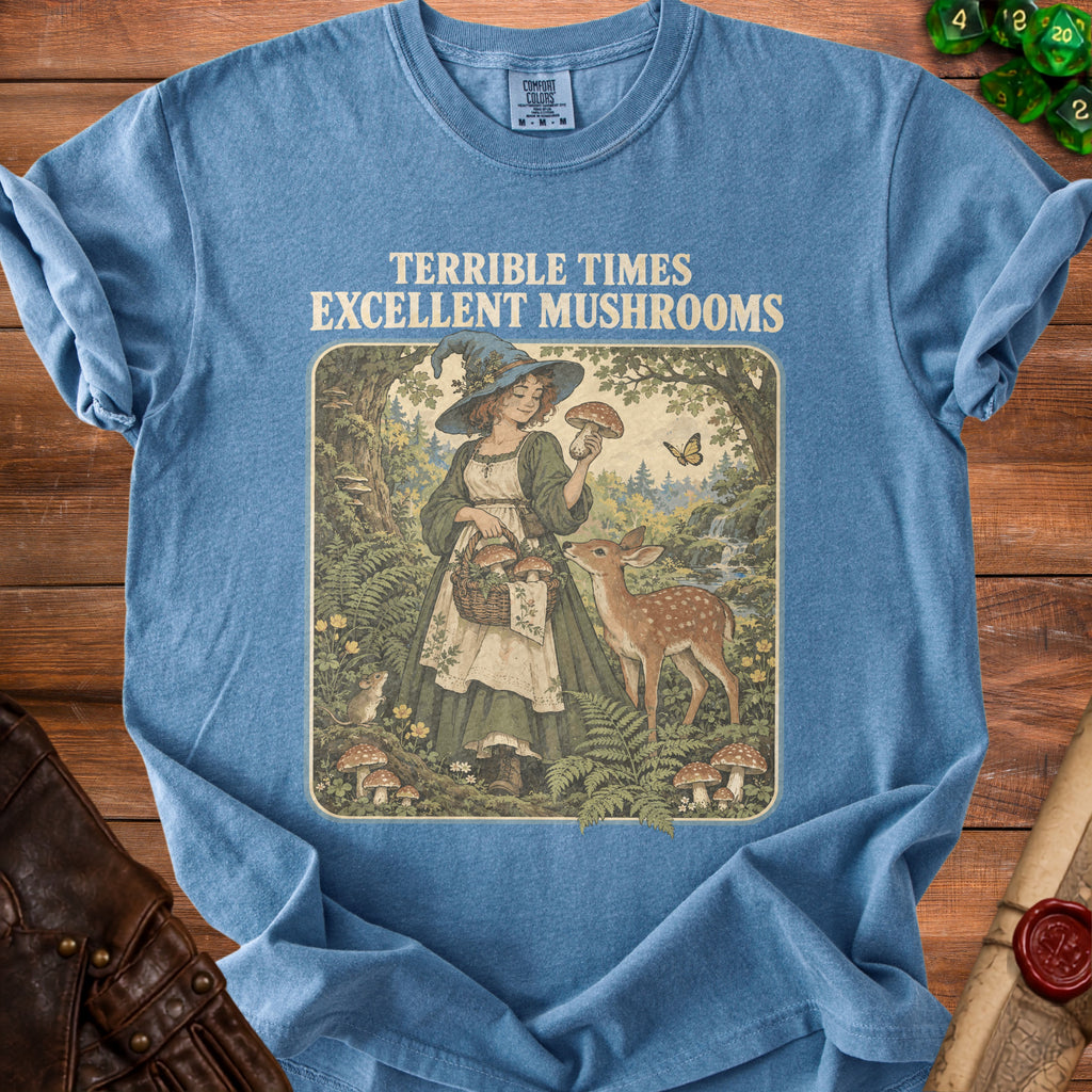 T-shirt with "Terrible Times Excellent Mushrooms" text and vintage witch picking mushrooms with deer.